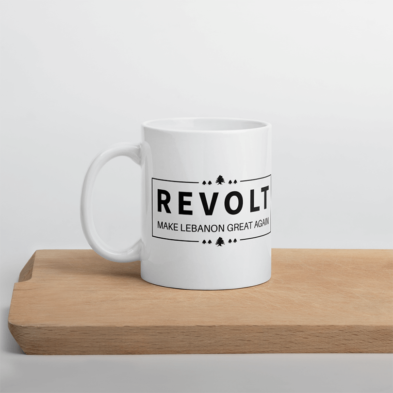 A white mug with a design saying 'Revolt - Make Lebanon Great Again' as requested by the client.